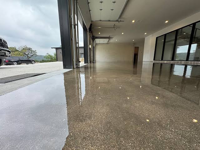 Close-up of sealed decorative stained concrete with water beading on the surface