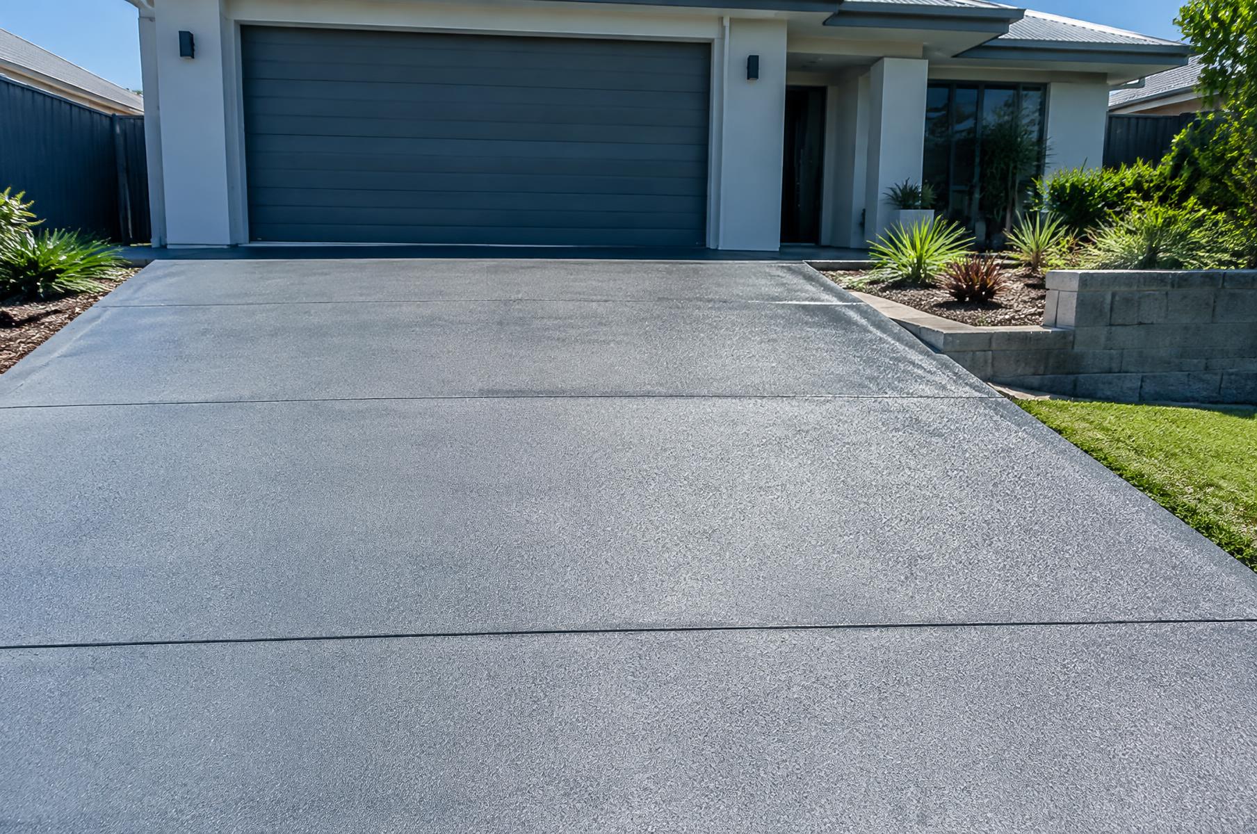 Resurfaced and sealed tan concrete driveway in Orange Park, FL